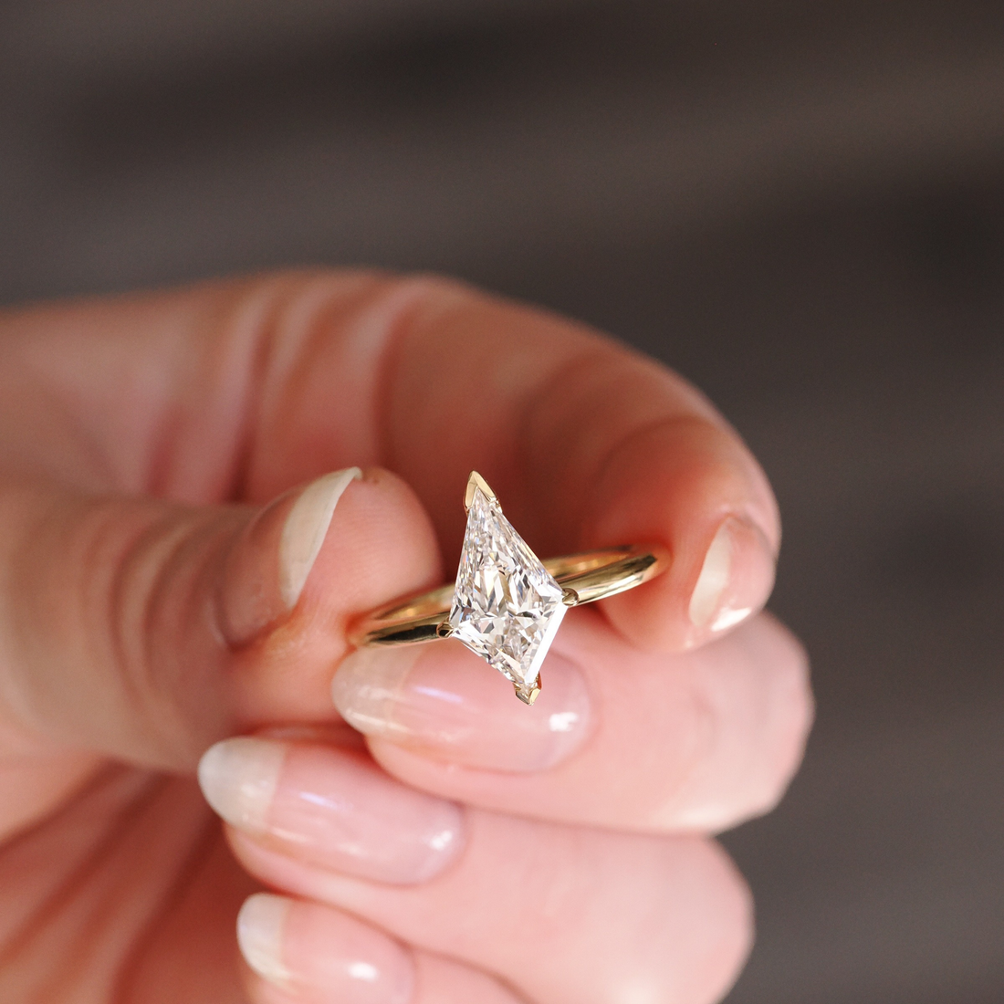 Radiant-cut diamond engagement ring in yellow gold handcrafted by Ethan Lord Jewelers, photographed close-up to highlight the diamond’s brilliance and elegant modern setting.